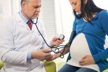 A pregnant woman is being tested for high blood pressure by her doctor.